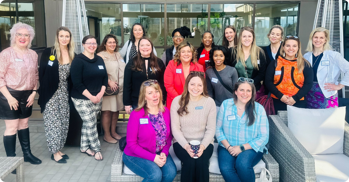 A large group of diverse women entrepreneurs in Alaska posing at an event. A large group of diverse women entrepreneurs in Alaska posing at an event.