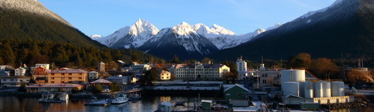 A landscape photo of rural Sitka, Alaska over the water with boats. A landscape photo of rural Sitka, Alaska over the water with boats.
